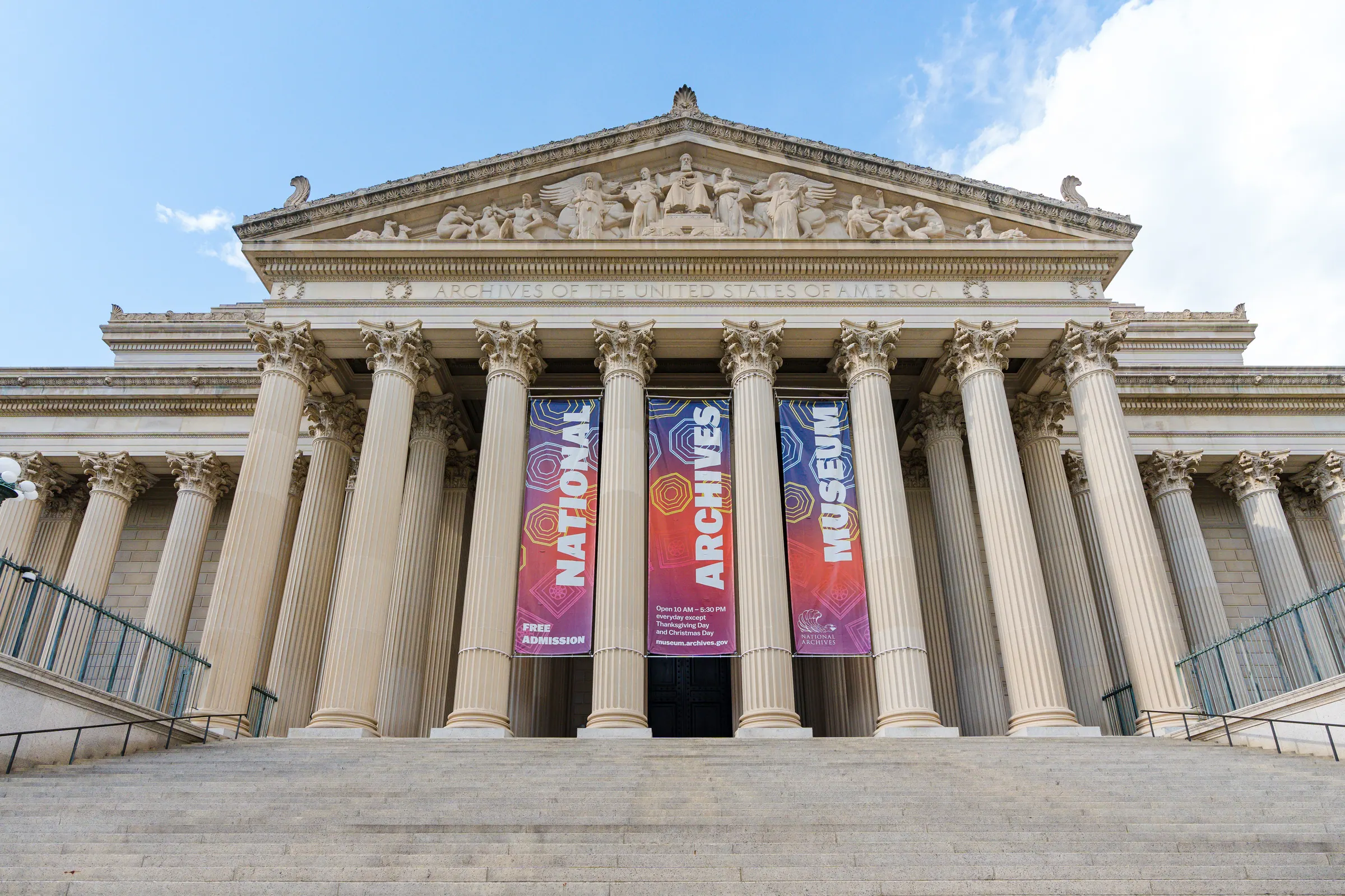 The National Archives Building on Constitution Avenue, its columns hung with the museum banners